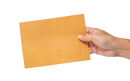 Man's hand holding envelope isolated on white background. Close up. High resolution productの写真素材