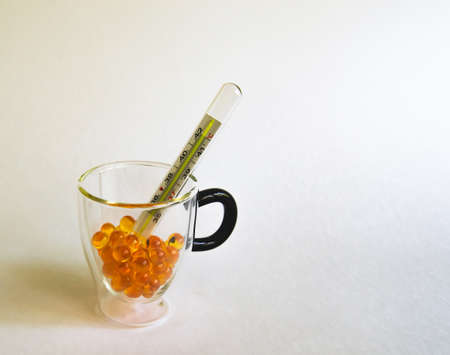 close-up shot of pills and medical mercury thermometersの写真素材