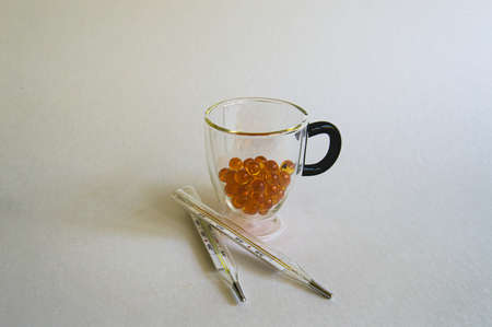 close-up shot of pills and medical mercury thermometers