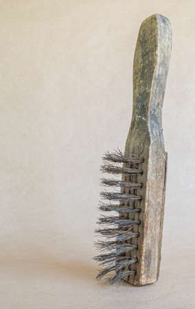 Vintage brush with metal bristles, isolated on paper background.の写真素材