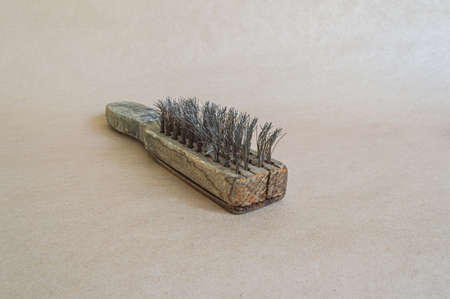 Vintage brush with metal bristles, isolated on paper background.の写真素材