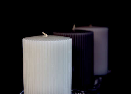 Three thick unlit candles in the darkの写真素材