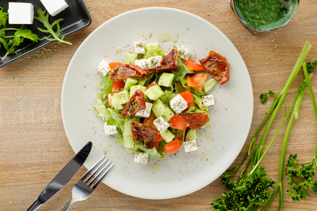 sliced summer salad served with vegetables and sauceの写真素材