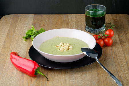 served plate of cream soup with juiceの写真素材