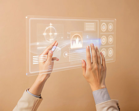 Close-up of female hands touching virtual panel on beige background