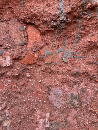 Texture of old rustic wall covered with red stucco. Abstract background for design.