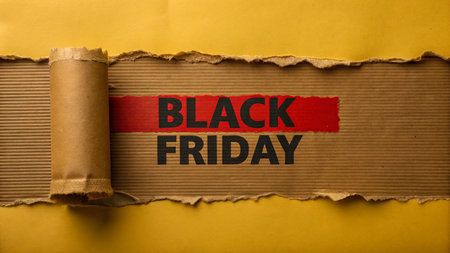 Black Friday text on torn brown paper with space for your text.の写真素材