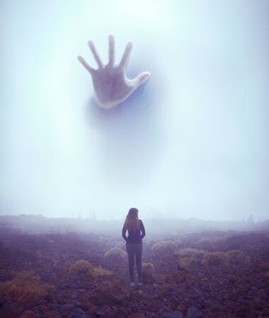 Woman facing a monster that hides in the fogの写真素材