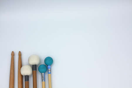 Percussion mallets set on a white background with text space.