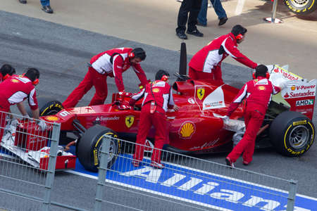 BARCELONA, SPAIN, March 3:  Felipe Massa (BRA) and her Ferrari machanicals during Formula One Teams Test Days at Catalunya circuit March 3, 2012 in Barcelona (Spain)のeditorial素材