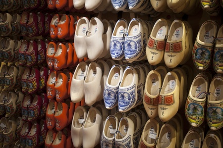 Big choice of wooden shoes Dutch souvenirs hanging on wall in shopのeditorial素材