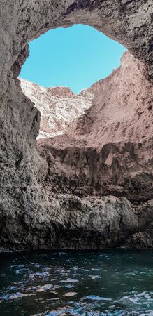 stone wall hole rock cave sea, rock and skyの写真素材