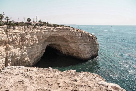 beach and rocks and sea, white, cave, cliffの写真素材