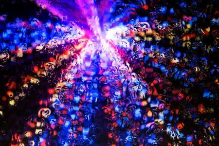 Neon lights behind water drops close upの写真素材