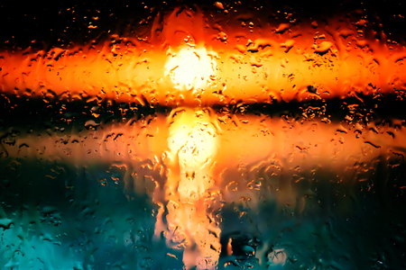 Neon lights behind water drops close upの写真素材