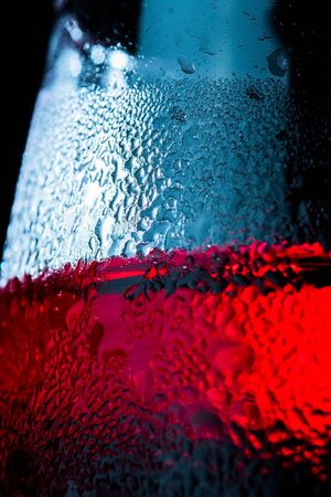 Detail of glass with red drink, cold, drops, backgroundの写真素材