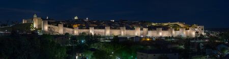 Walls surrounding Spanish city of Avila, night panoramaの写真素材