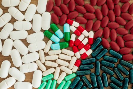 Capsule and pills medicines in wood background close upの写真素材