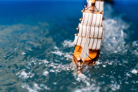 small toy boat in the water with big waves,の写真素材