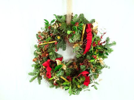 Christmas wreath with poinsettia, holly and ivyの写真素材