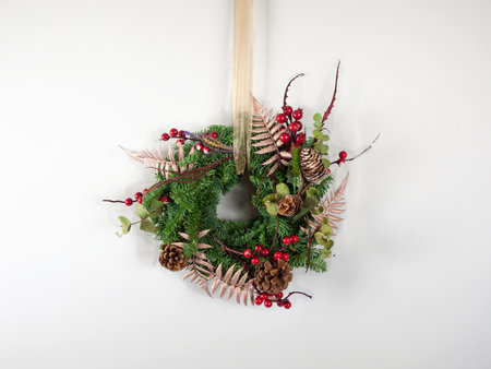 Christmas wreath with pine cones, holly berries and ivyの写真素材