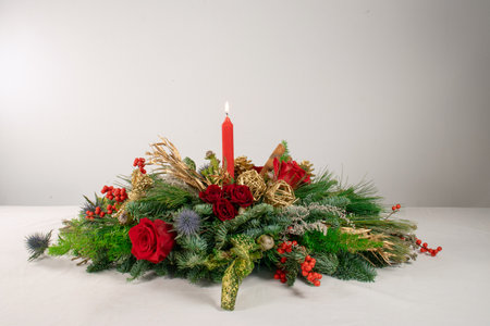 Christmas and New Year decoration with red candle and green fir branches.の写真素材