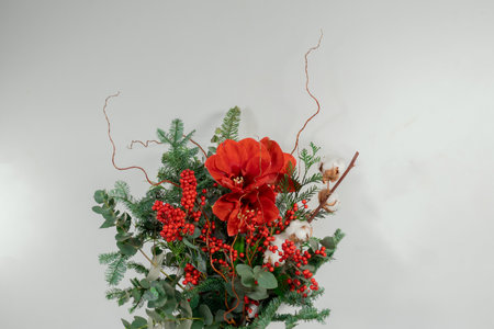 Christmas bouquet of red poinsettia, holly berry and eucalyptus on white backgroundの写真素材