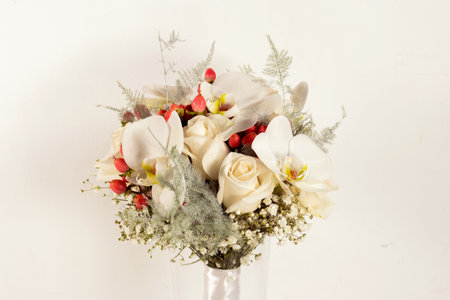 Bouquet of white and red flowers in vase on white backgroundの写真素材