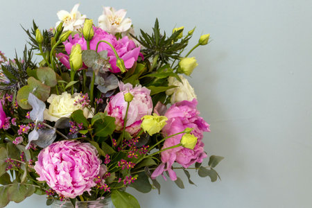 Bouquet of flowers in a vase on a gray backgroundの写真素材
