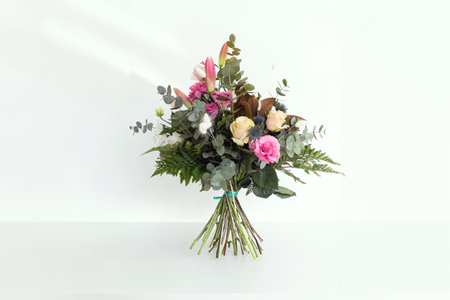 Bouquet of ornamental flowers in vase on the white table.の写真素材
