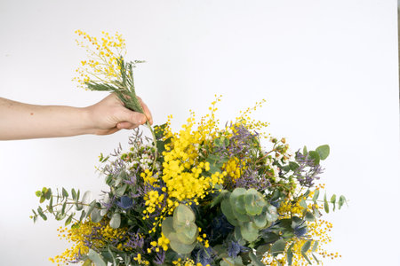 nice bouquet in the hands of a girl on a white backgroundの写真素材