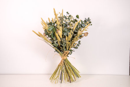 Bouquet of dried flowers in vase on white background.の写真素材