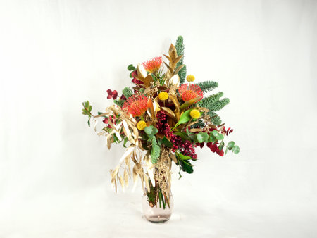 Christmas bouquet of flowers in vase on white background.の写真素材