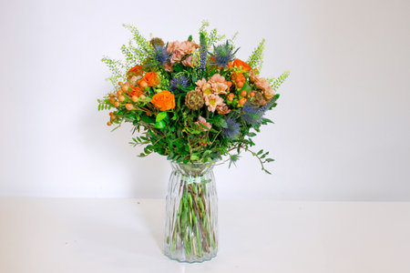 Bouquet of flowers in glass vase on white background.の写真素材