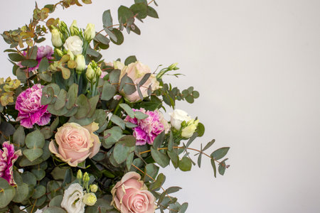 Bouquet of champagne pink roses and eucalyptus on white background with space for textの写真素材