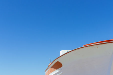 Detail of the hull of a ship against the blue sky with space for text.の写真素材