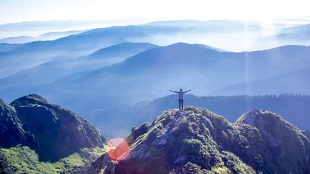 Man on the top of the mountain range of Carpathians mountainsの写真素材