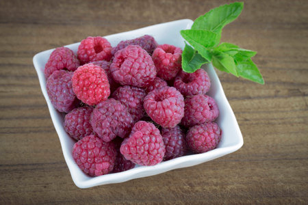 Raspberries in a white cupの写真素材