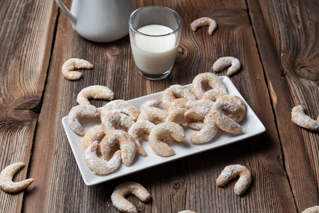 Vanille cookies and milk on a wooden tableの写真素材