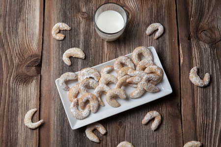 Vanille cookies and milk on a wooden tableの写真素材