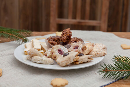Christmas cookies on a wooden table with tea and cinnamonの写真素材