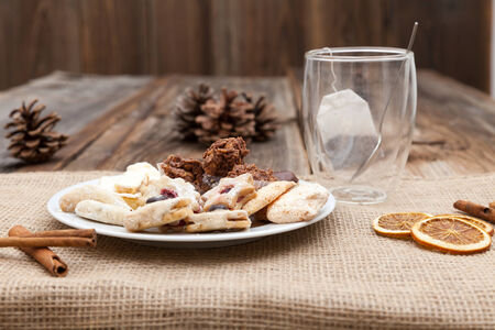 Christmas cookies on a wooden table with tea and cinnamonの写真素材