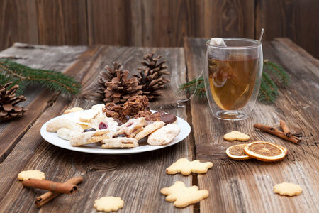 Christmas cookies on a wooden table with tea and cinnamonの写真素材