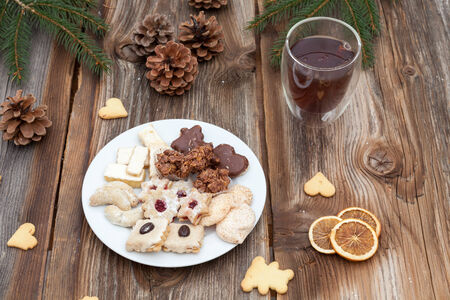 Christmas cookies on a wooden table with tea and cinnamonの写真素材