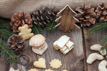 Christmas cookies on a wooden table with tea and cinnamonの写真素材
