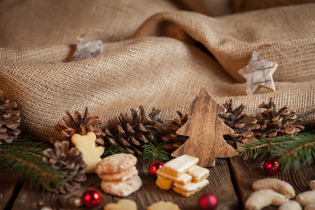 Christmas cookies on a wooden table with tea and cinnamonの写真素材