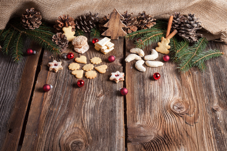 Christmas cookies on a wooden table with tea and cinnamonの写真素材
