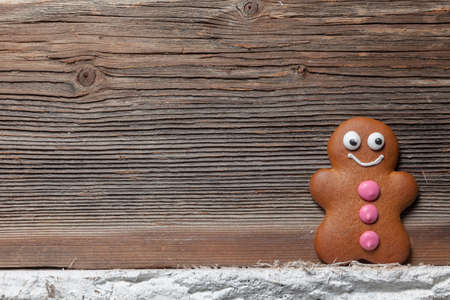 Gingerbread man in front of their christmas treeの写真素材