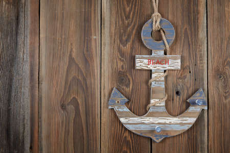 A beach sign on a brown wooden fenceの写真素材