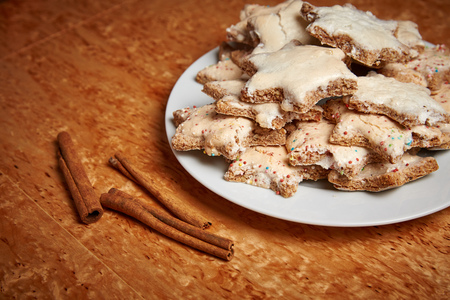 Cinnamon stars on a plate on a wooden tableの写真素材